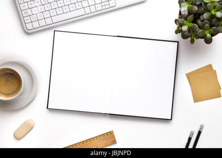 Open Blank Diary Surrounded With Office Supplies And Keyboard Stock Photo
