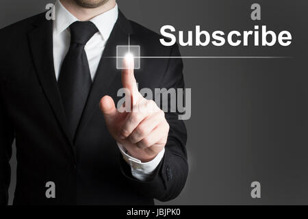 man in black suite pressing virutal button subscribe Stock Photo