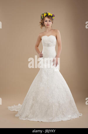 Charming Woman in Bridal Dress with Wreath of Flowers Stock Photo