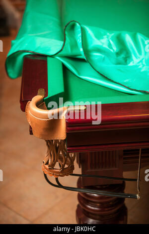 Billiard table under cloth cover with open pocket Stock Photo