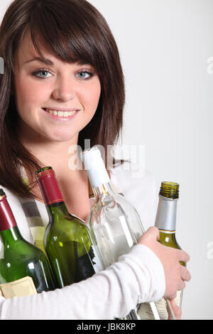 Young woman taking out the recycling Stock Photo