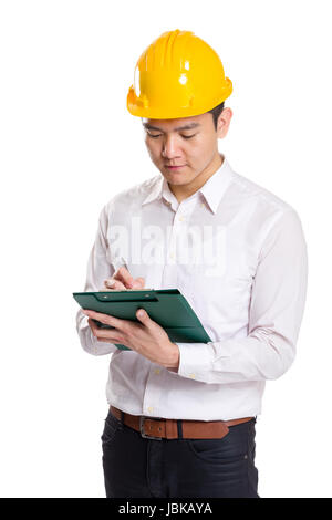 Asia engineer recording something on clipboard Stock Photo