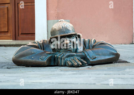 Cumil, emerging statue in the city of Bratislava, Slovakia.