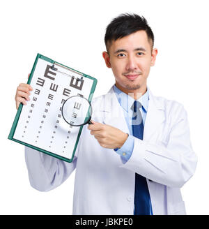 Male doctor holding optometry chart and magnifying glass Stock Photo