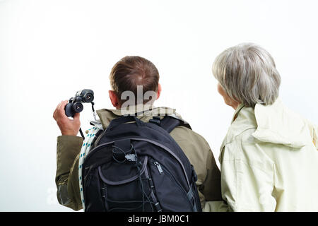 Backs of senior hikers on trip Stock Photo
