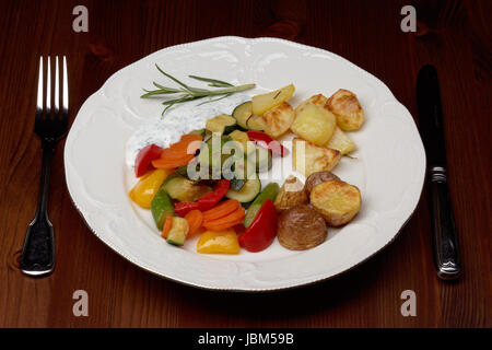 plate with vegetables and oven potatoes Stock Photo