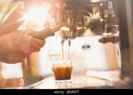 Close up hand of barista using espresso machine in cafe Stock Photo