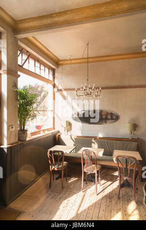 Wooden table with chairs and booth in empty vintage cafe Stock Photo