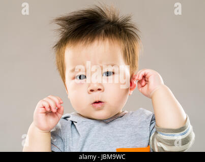 Adorable baby looking confused Stock Photo