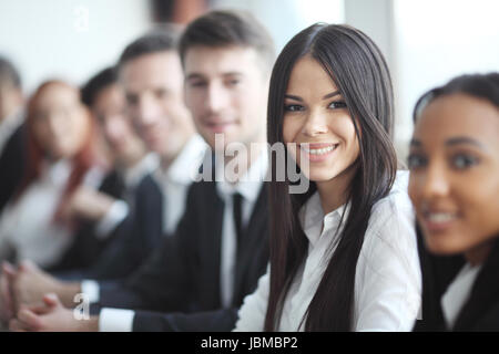 Business people sitting in a row and working, focus on pretty woman Stock Photo