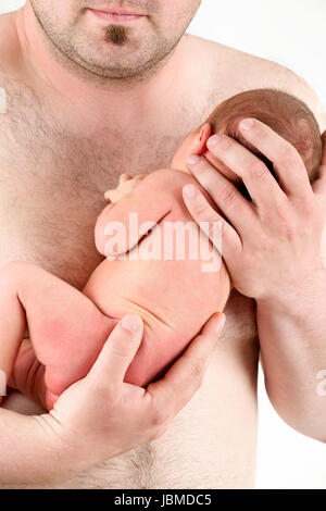 hands of a father holding his newborn baby girl , sleeping newborn baby in father hand - the first week of the new life Stock Photo