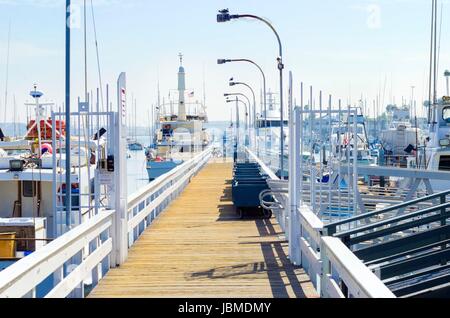 The Shelter island Marina in Point Loma, San Diego, Southern California, United States of America. A view of the pier and some yachts docked on the harbor. Stock Photo