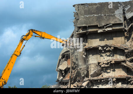 Heavy equipment being used to tear tearing down building construction Stock Photo