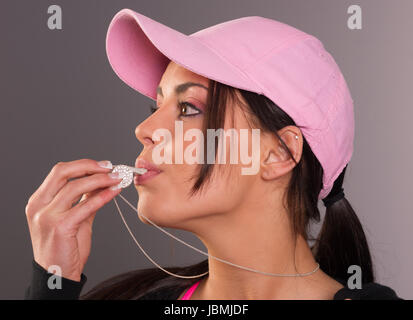 Lady blows star studded whistle Stock Photo