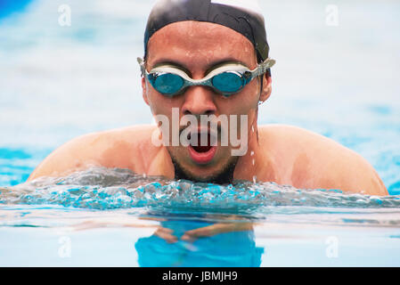 Close-up portrait of man swimming in pool. Man in swimmer goggles Stock Photo