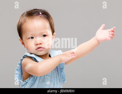 Baby girl with hand up Stock Photo