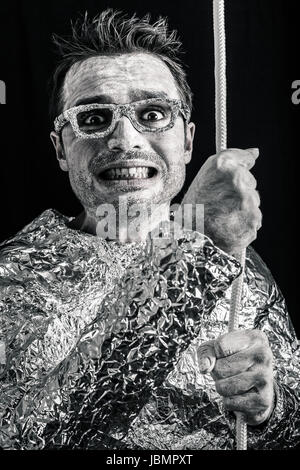 Crazy desperate alien man holding rope. Stock Photo