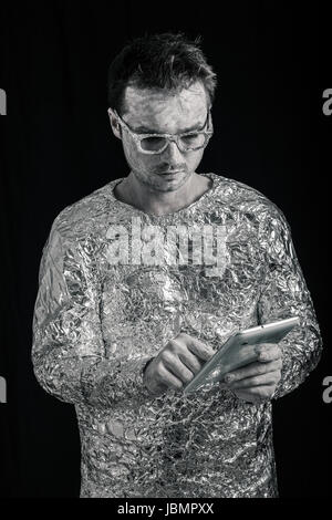 Portrait of spaceman using digital tablet. Stock Photo