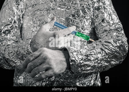 Closeup of cyborg hand applying syringe. Stock Photo