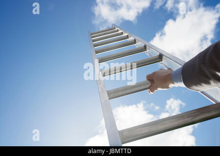 Businessman climbing the corporate ladder of success Stock Photo