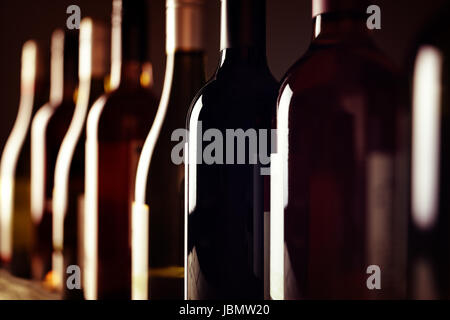 Bottles of old aged wine collection in a row in winery cellar Stock Photo