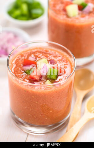 Traditional Spanish cold vegetable soup made of tomato, cucumber, bell pepper, onion, garlic and olive oil served in glasses (Selective Focus, Focus on the front of the vegetables on the top of the soup) Stock Photo
