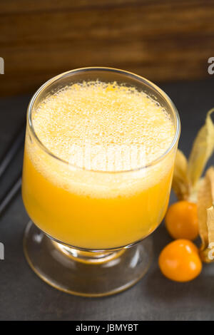 Peruvian cocktail called Aguaymanto Sour (Physalis Sour) prepared from physalis juice, pisco (Peruvian grape hard liquor), syrup and egg white (Selective Focus, Focus in the middle of the froth) Stock Photo