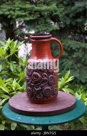 Decorative amphora on the table in the garden Stock Photo