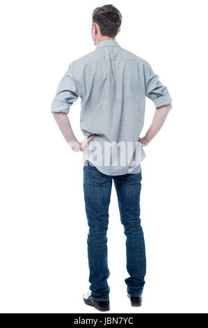 Back pose, full length shot of a young man looks ahead Stock Photo