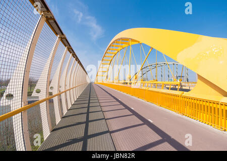 detail of the yellow arch bridge in Utrecht, netherlands. The Hogeweide Bridge is a steel arch bridge over the Amsterdam-Rhine Canal Stock Photo