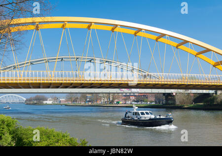 yellow arch bridge in Utrecht, netherlands. The Hogeweide Bridge is a steel arch bridge over the Amsterdam-Rhine Canal Stock Photo