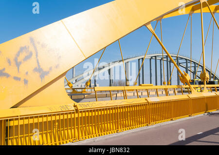 detail of the yellow arch bridge in Utrecht, netherlands. The Hogeweide Bridge is a steel arch bridge over the Amsterdam-Rhine Canal Stock Photo