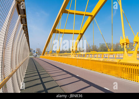 detail of the yellow arch bridge in Utrecht, netherlands. The Hogeweide Bridge is a steel arch bridge over the Amsterdam-Rhine Canal Stock Photo