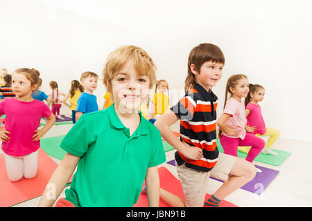Portrait of smiling blond kid boy at sports lesson in fitness center Stock Photo