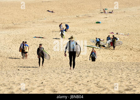 Surfers leaving Capbreton beach in South Western France Stock Photo