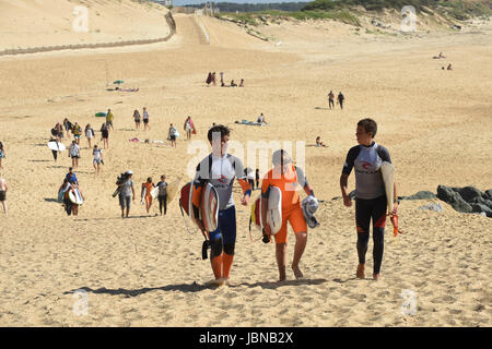 Surfers leaving Capbreton beach in South Western France Stock Photo