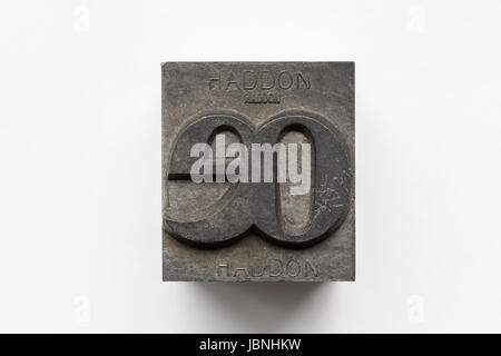 Old letterpress metal type printing block isolated on a white background Stock Photo