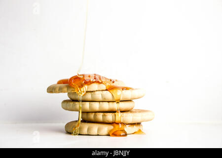 Cookie cracker round pile. A drop of sticky honey on top of the pour. Photo for your design Stock Photo
