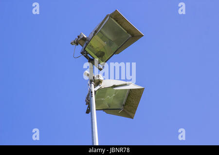 An example of floodlights against a clear blue sky on a local village cricket club grounds in Hampshire in England Stock Photo