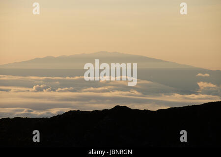 Mauna Kea seen from Haleakala Crater at Sunrise Stock Photo