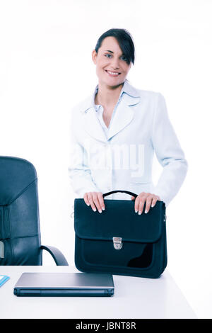 Young attractive business woman with briefcase at the office. Business concept. Toned image Stock Photo