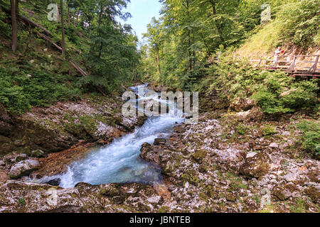 Bled, Slovenia - June 3, 2017: Tourists walking inside the Vintgar Gorge on a wooden path between Bled Lake and Bohinj Lake in Slovenia, Europe. Stock Photo