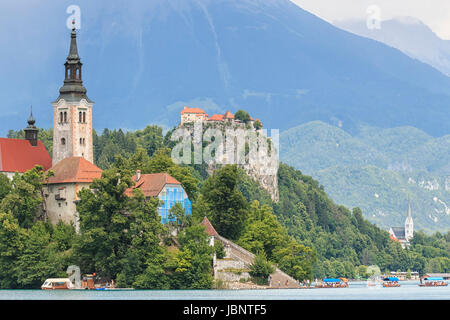 Bled, Slovenia - June 3, 2017: Tourists visiting the Cerkev Marijinega vnebovzetja Church in the Island in the center of Lake Bled. Stock Photo