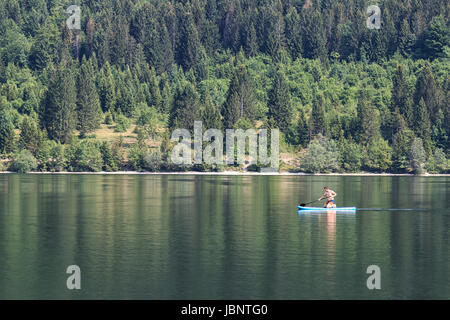 Bohinj, Slovenia - June 4, 2017: Tourist on a small boat in lake Bohinj, a famous destination not far from lake Bled. Stock Photo