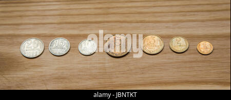 Old soviet couns on a wooden background. Hisoric, used currency. Stock Photo