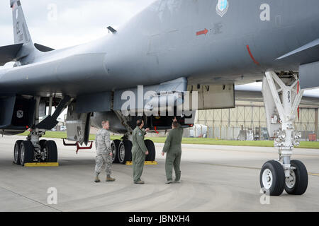 The flight crew of a B-1B Lancer check over the bomber as it sits on the pan at RAF Fairford. Stock Photo