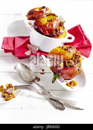 Savoury filled baked apples with pink mint Stock Photo