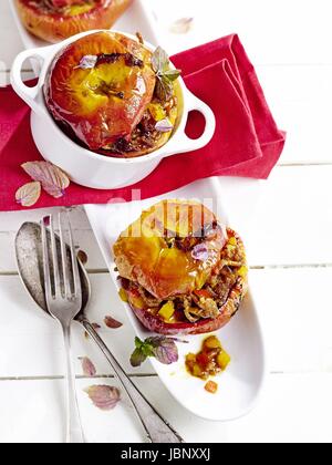 Savoury filled baked apples with pink mint Stock Photo