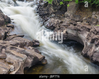 Fast flowing river in the landscape of the Elan Valley, Wales, at long shutterspeed to get a silky appearance Stock Photo