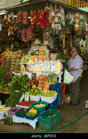LIMA, PERU - FEBRUARY 13, 2012: Unidentified person at fruit and vegetable stand on the market called Mercado No 1 de Surquillo on February 13, 2012 in Lima, Peru. There are many fruit and vegetable markets in  Lima, which have a very good selection and are usually cheaper than supermarkets. Stock Photo